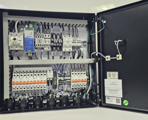 UL 508A-compliant industrial control panel designed by DRF Engineering for red light therapy power distribution, showcasing internal wiring and circuit components.