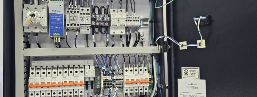 UL 508A-compliant industrial control panel designed by DRF Engineering for red light therapy power distribution, showcasing internal wiring and circuit components.
